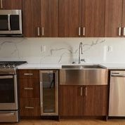 A kitchen with wooden cabinets and stainless steel appliances.