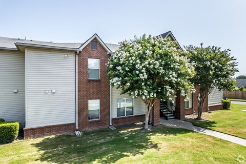 A house with a red brick exterior and a white garage door.