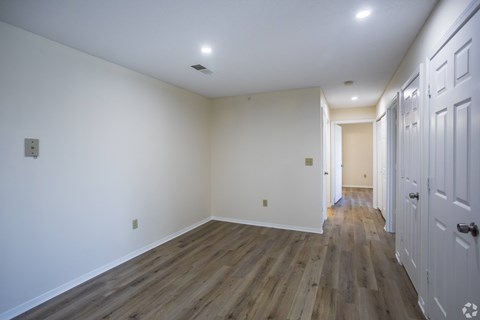 A room with white walls and wood flooring.