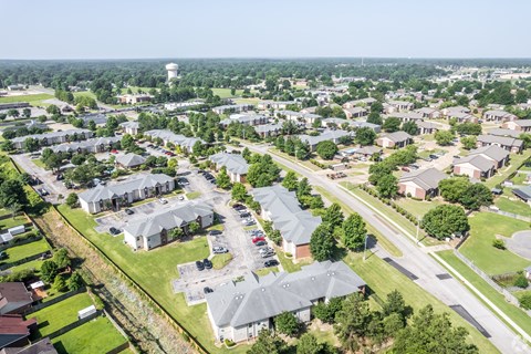 A bird's eye view of a residential area with houses and a water tower in the distance.
