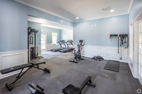 A spacious home gym with a variety of exercise equipment.