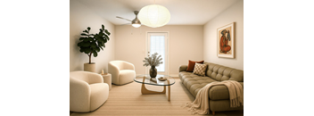 A living room with a sofa, armchairs, a coffee table, and a ceiling fan.