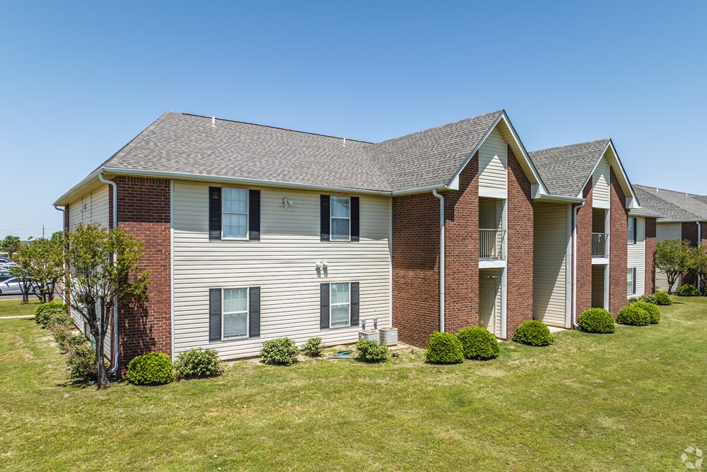 A house with a red brick chimney and a grey roof.