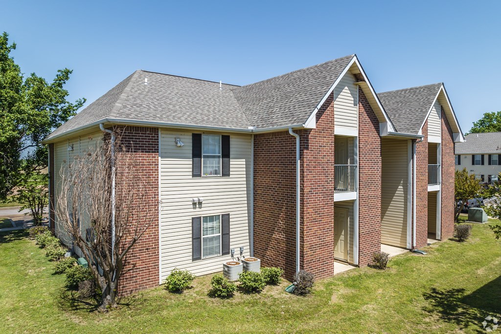 A house with a grey roof and red brick walls.