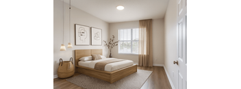 A bedroom with a large bed and two hanging lamps.