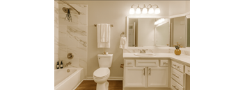 A white bathroom with a toilet, sink, and bathtub.