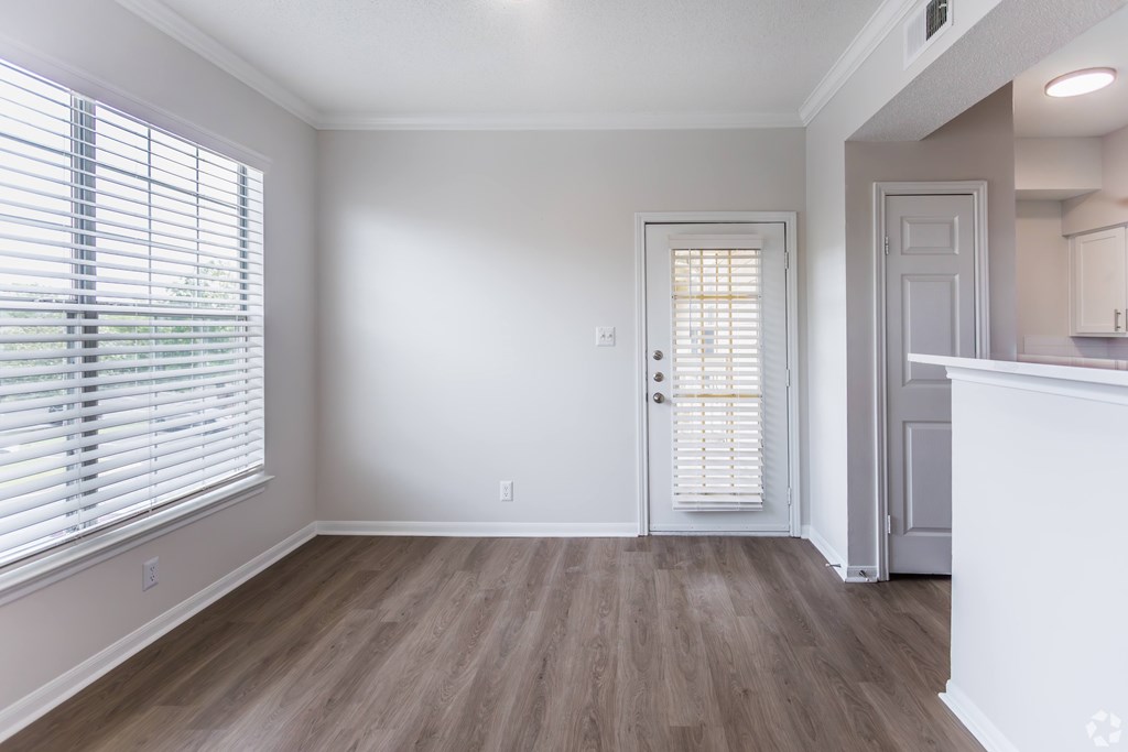 A room with a wooden floor and a white door.