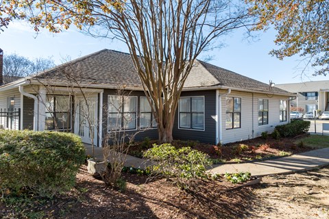 A house with a tree in front of it.