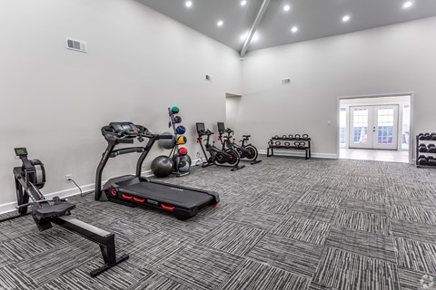 A spacious gym with a variety of exercise equipment.