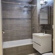 A white sink is on a counter in a bathroom.