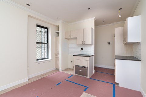 A kitchen area with a countertop and cabinets.