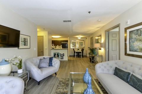A living room with a white couch and a grey armchair.