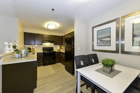 A modern kitchen with a dining table and chairs.
