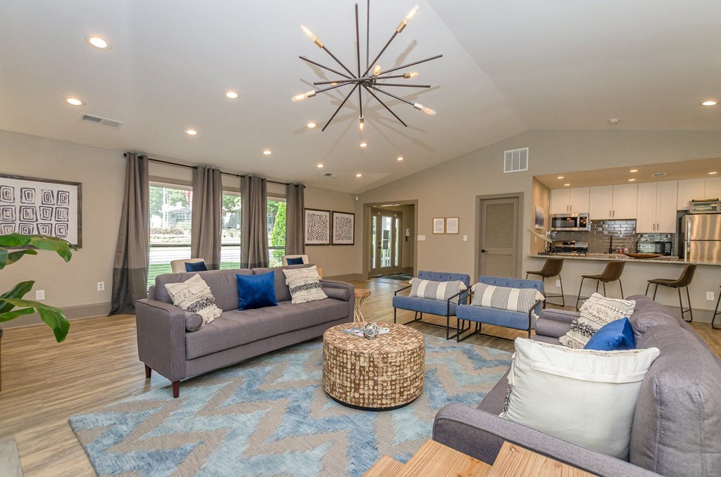 A modern living room with a grey sofa and a woven coffee table.