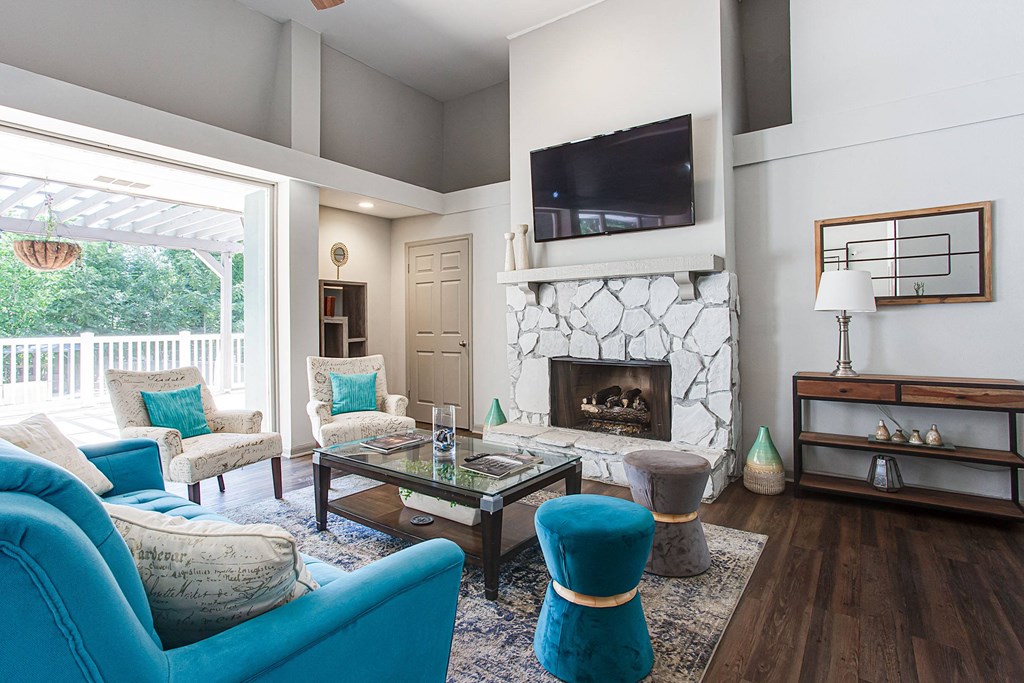 A living room with a fireplace and a television mounted on the wall.