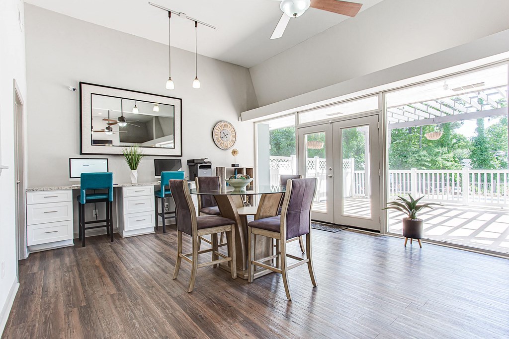 A dining room with a wooden table and chairs.