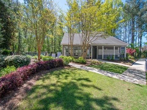 A house with a front yard and trees.