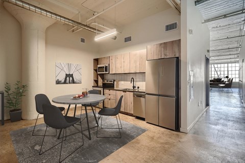 A modern kitchen with a dining table and chairs.