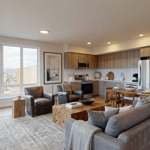 A modern living room with a grey couch and a wooden coffee table.