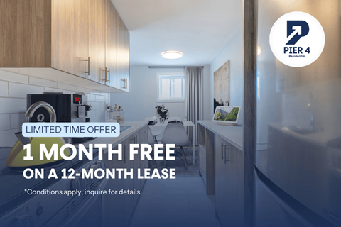 A kitchen interior with a sign offering a free month on a lease.