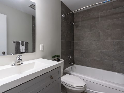 A bathroom with a white sink, toilet, and bathtub.