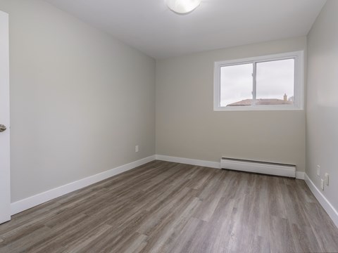 A room with a window and a door.