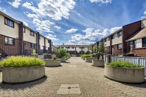 A sunny day in a courtyard surrounded by residential buildings.
