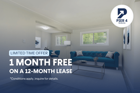 A living room with a blue couch and a 1 month free offer on a 12-month lease.