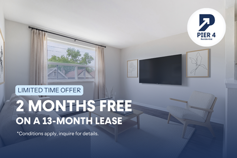A room with a chair and a television mounted on the wall, advertising a limited time offer for a free 2 months on a 13-month lease.