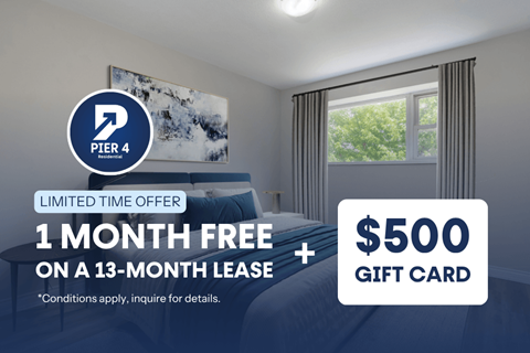 A bedroom with a bed, window, and a poster on the wall with a $500 gift card offer.