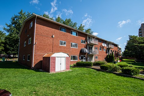 A red brick building with a white garage door.