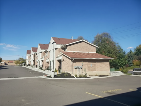 A large building with a parking lot in front of it.
