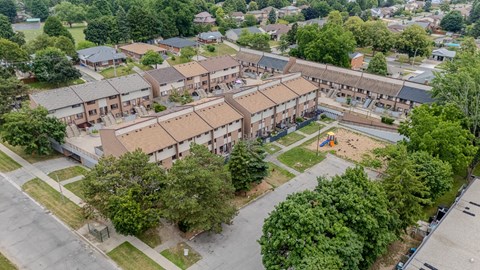An aerial view of a residential area with apartment buildings and a playground.