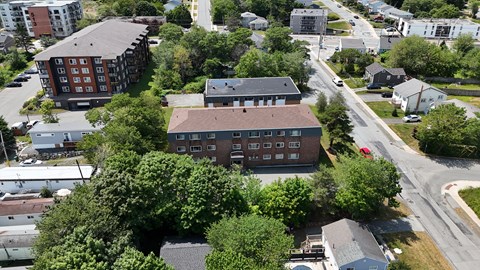 A bird's eye view of a residential area with houses and trees.