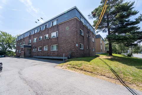 A large brick building with a crane in the background.