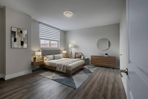 A bedroom with a bed, nightstands, and a painting on the wall.