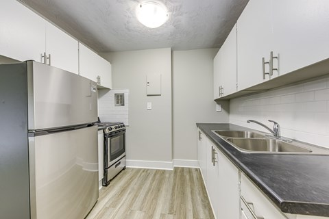 A kitchen with a stainless steel refrigerator and oven.