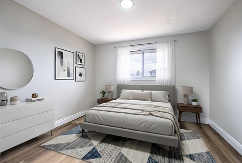 A bedroom with a large bed and a white dresser.