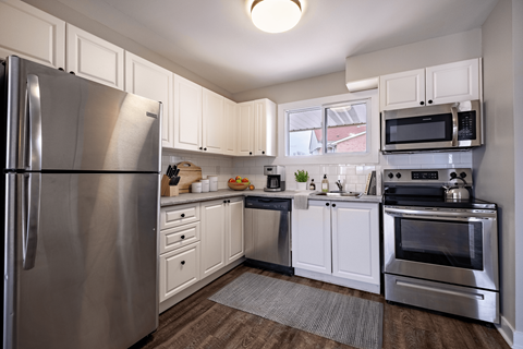 A kitchen with a stainless steel refrigerator and oven.