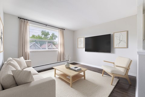 A living room with a couch, chair, and television.