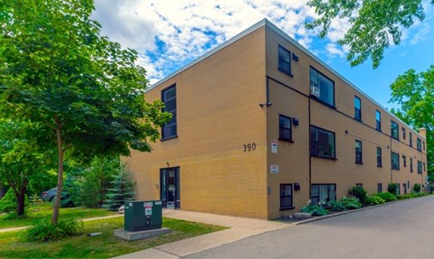 A building with the number 390 on it is surrounded by greenery.