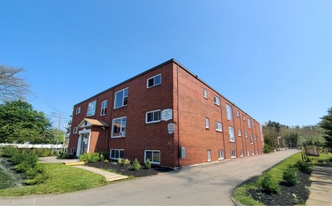 A red brick building with a clear blue sky in the background.