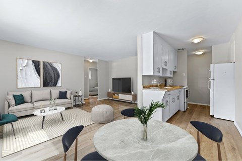 A modern living room with a grey marble table and black chairs.