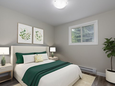 A bedroom with a large bed and a window showing trees outside.