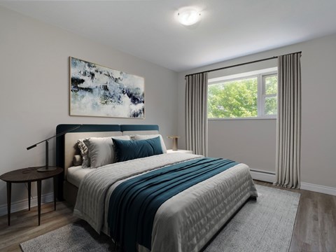 A bedroom with a large bed and a painting on the wall.