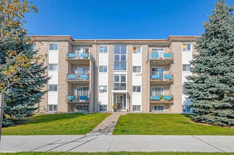 A large apartment building with a balcony on the second floor.