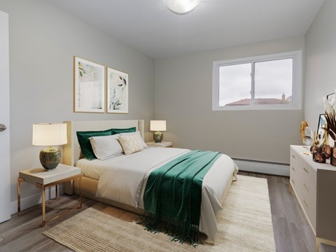 A bedroom with a bed, nightstands, and a window.