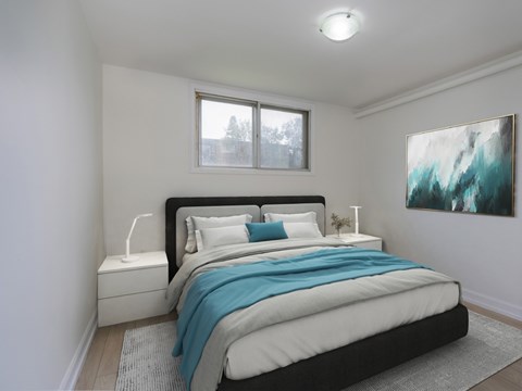 A bedroom with a large bed and a painting on the wall.
