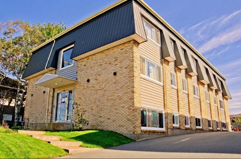 A modern building with a combination of brick and siding exterior.