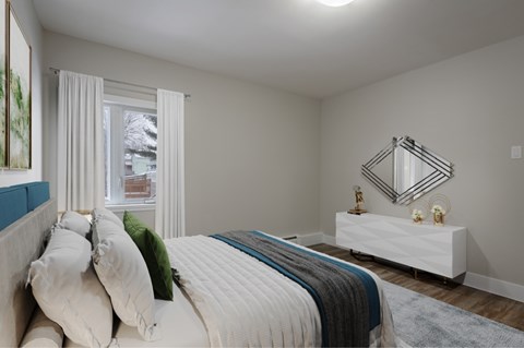 A bedroom with a large bed and a white dresser.